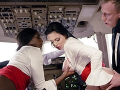 The lucky pilot is in a cockpit with two tremendous stewardesses