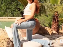 Redhead teaser in light blue jeans Lucy Anne is taking off her tiny top