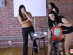 4 women have fun a game of unwrap pop the balloon