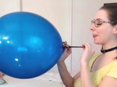 Lintilla blows up a huge blue balloon