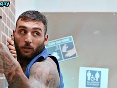 A manly athlete with a muscular and tattooed body fucks a police officer in the bathroom
