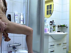 Woman fucks herself with a big dildo in front of the shower mirror and masturbates. AnnaHomeMix