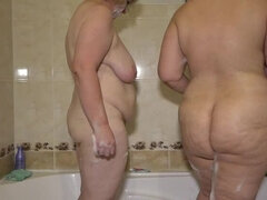Mature lesbians in the bathroom. A chubby milf with big tits washes a fat girlfriend with a juicy PAWG. Homemade fetish.