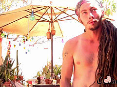 Dreadlocks fellow plays with his sack and meatpipe outdoors