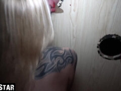 Tattooed blonde German mom gives handjob through gloryhole with cum on face and tits