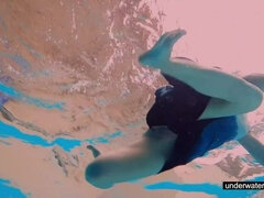 Teen girl Avenna is swimming in the pool