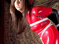 Tiffany in red catsuit and an armbinder