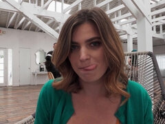 Slutty rouge with short hair Nicole Rae lifts up her skirt in public, sits down on a chair and starts pussy fingering, while moaning and squirting.