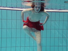 Red Dressed teenage swimming with her eyes opened