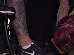 Ligatured redhead cleaning shoes in public bar