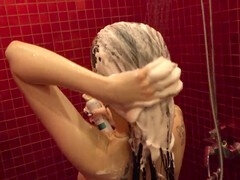 Woman enjoying a sudsy hair wash in the shower