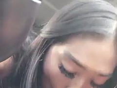 Petite Asian gives interracial blowjob in car