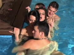 Horny broads are having an orgy in the pool with some guys here