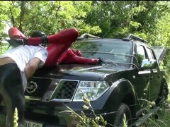Dame Total Encased in Crimson Spandex with Condom Mask and Mittens Pounded on Truck