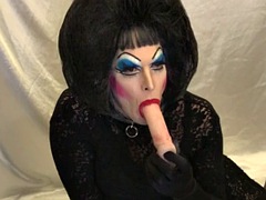 Slut with heavy makeup sucks and deepthroats a dildo