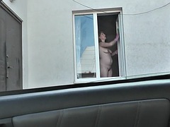 Neighbor taxi driver watches MILF neighbor washing apartment window naked. Naked in public