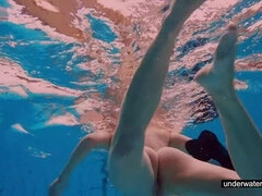 Teen girl Avenna is swimming in the pool